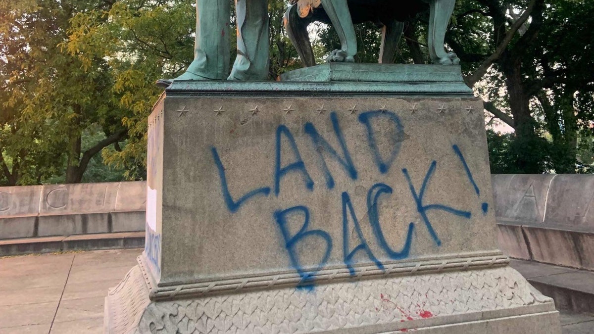 Graffiti vandalism on the base of the Lincoln statue in Chicago
