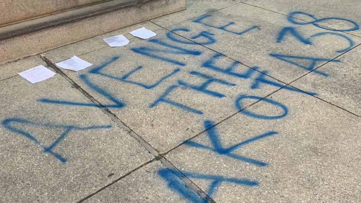 Graffiti at the base of the Lincoln statue in Chicago