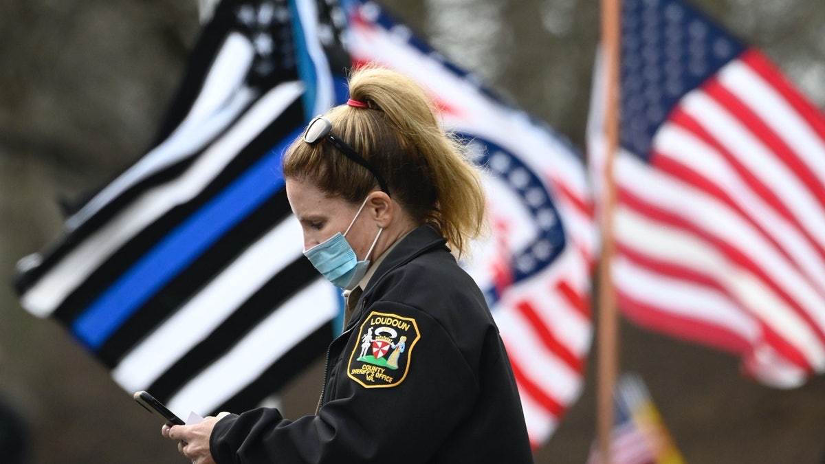 Loudoun County police officer looks at phone