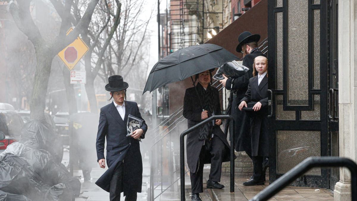 Men arrive to a Orthodox Synagogue in Brooklyn on December 30, 2019 in New York City, two days after an intruder wounded five people at a rabbi's house in Monsey, New York during a gathering to celebrate the Jewish festival of Hanukkah.