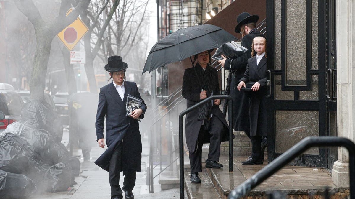 Men arrive to a Orthodox Synagogue in Brooklyn on December 30, 2019 in New York City, two days after an intruder wounded five people at a rabbi's house in Monsey, New York during a gathering to celebrate the Jewish festival of Hanukkah.