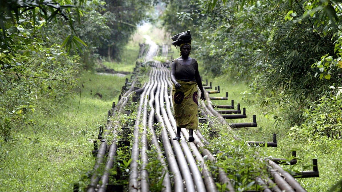 Woman walking on an oil pipeline