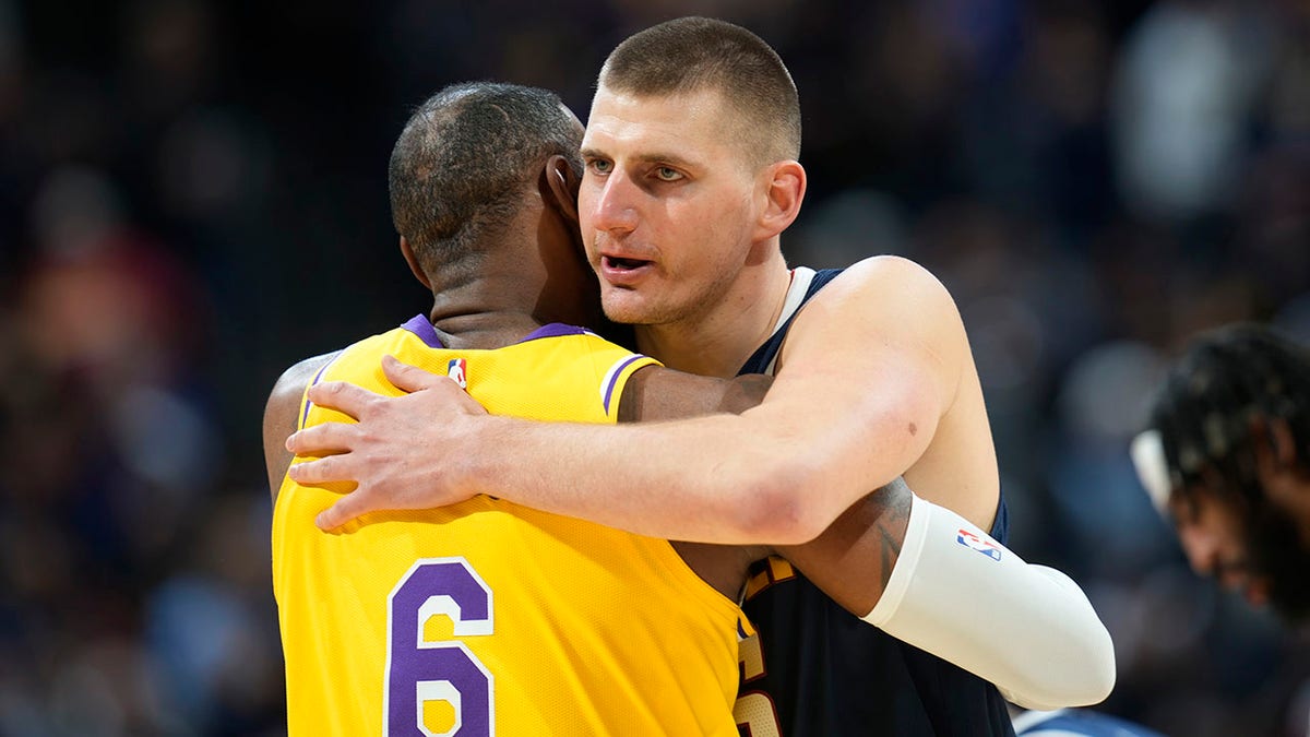 Nikola Jokic hugs LeBron James