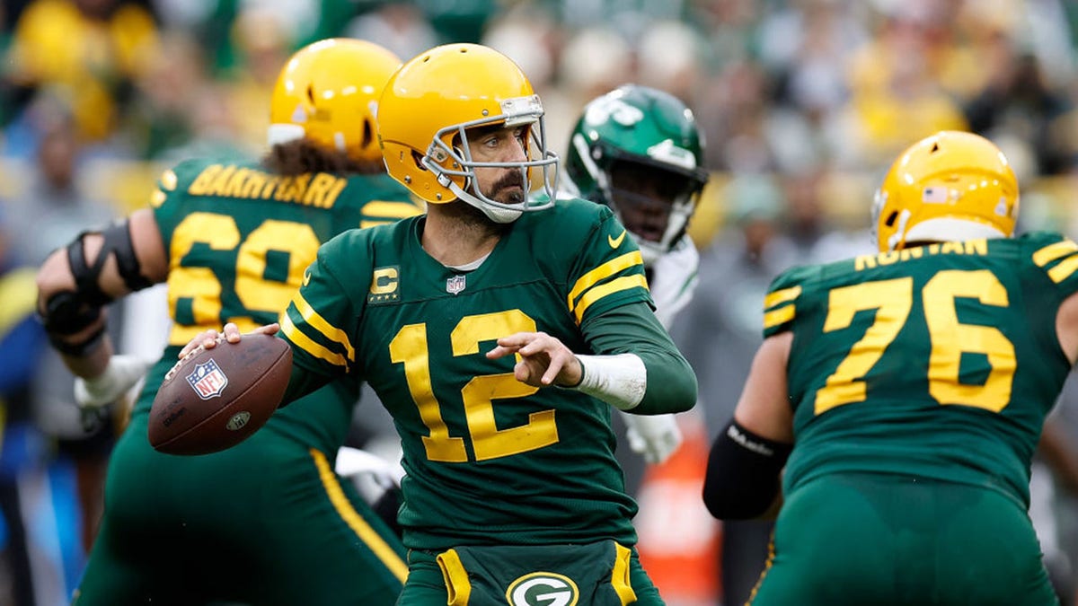 Aaron Rodgers drops back to pass