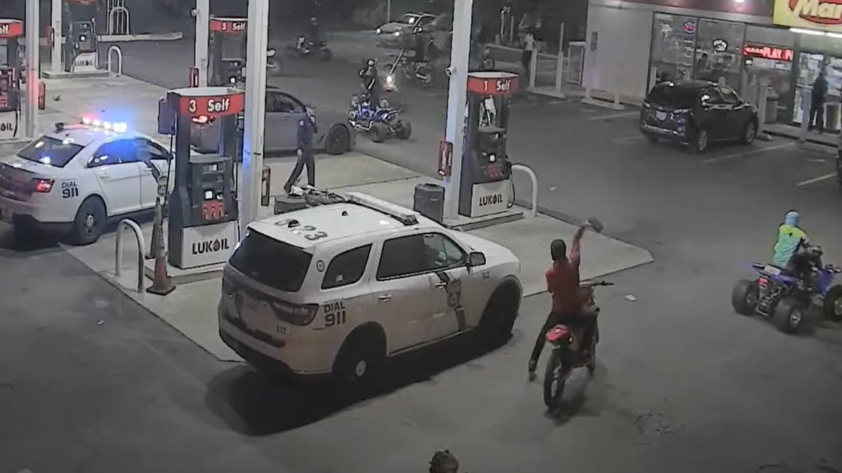 Philadelphia police vehicle parked at a gas station attacked by bricks