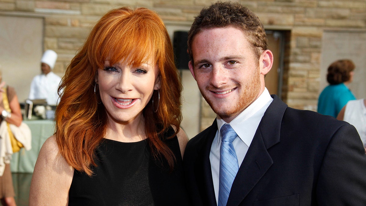 Reba McEntire wears black dress to awards with her son.