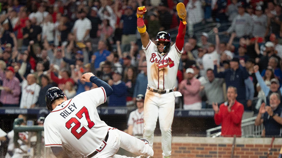 Braves players Ronald Acuna Jr. and Austin Riley score