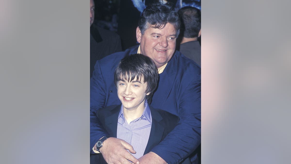 Robbie Coltrane and Daniel Radcliffe pose for a photo