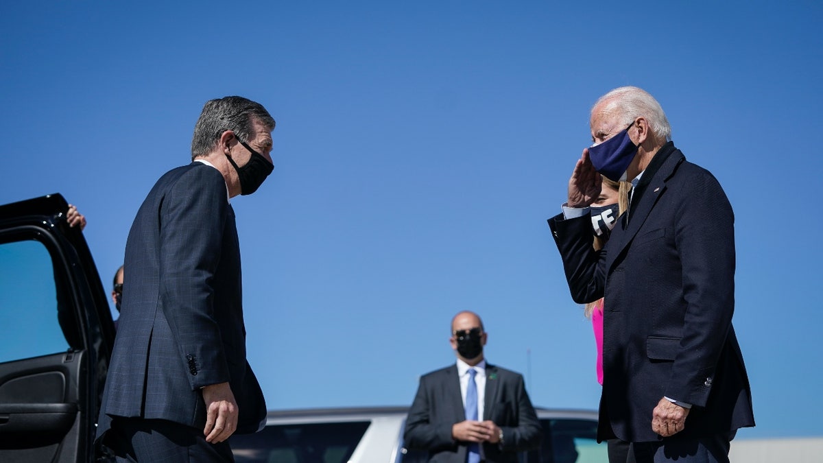 Gov. Roy Cooper greeting President Biden