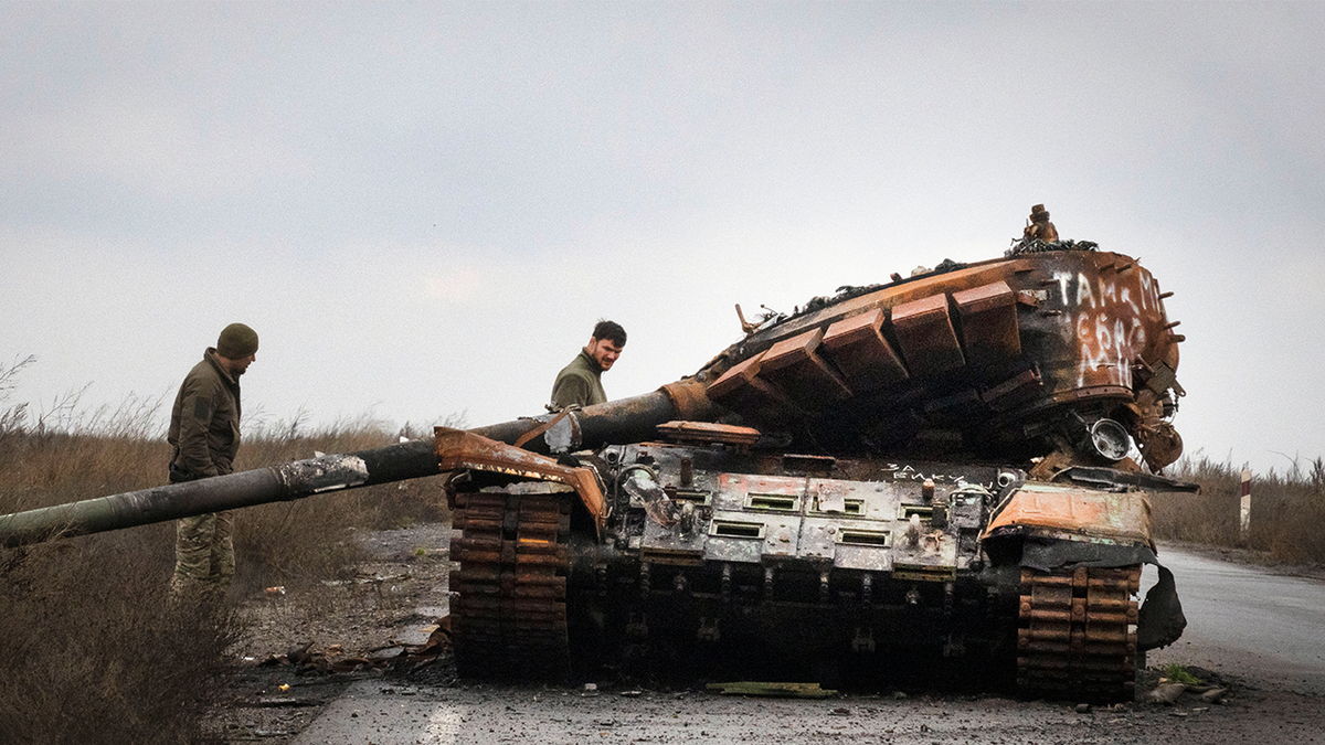 Ukrainian soldiers inspect tank