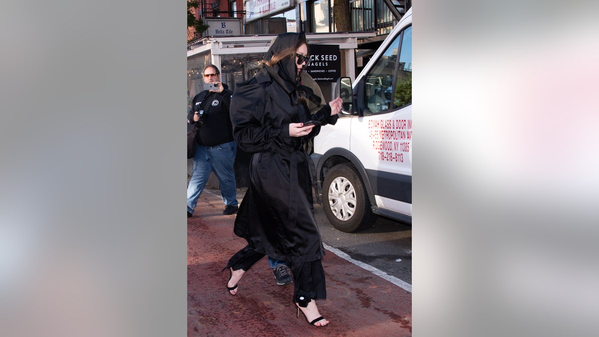 Anna Sorokin leaving NYC apartment wearing her GPS ankle monitor