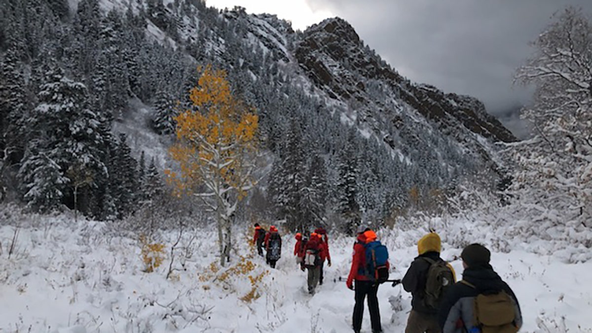 rescuers walking on snowy mountain