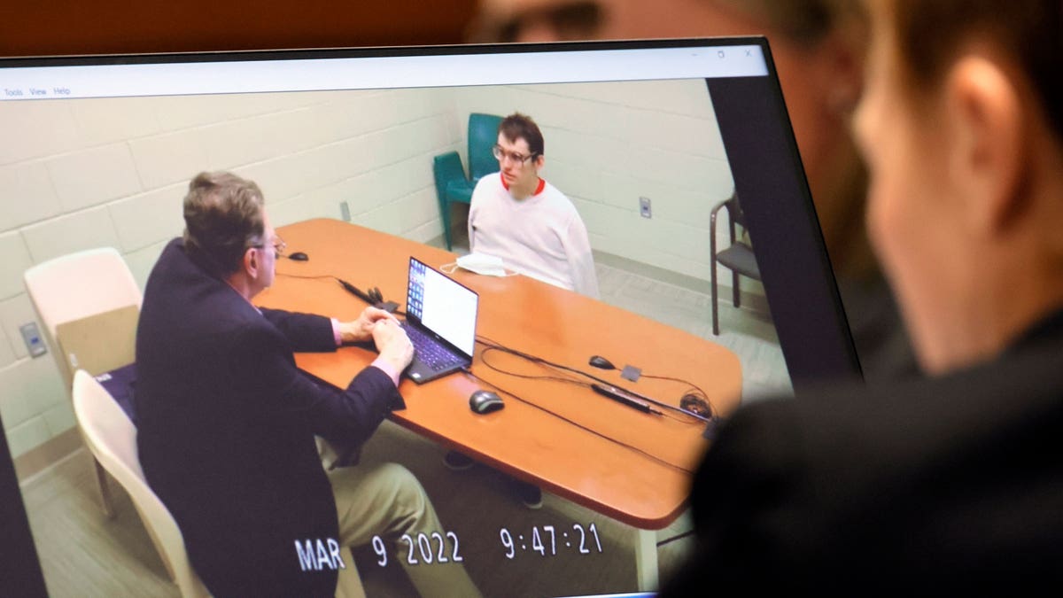 Nikolas Cruz in a straitjacket being interrogated 