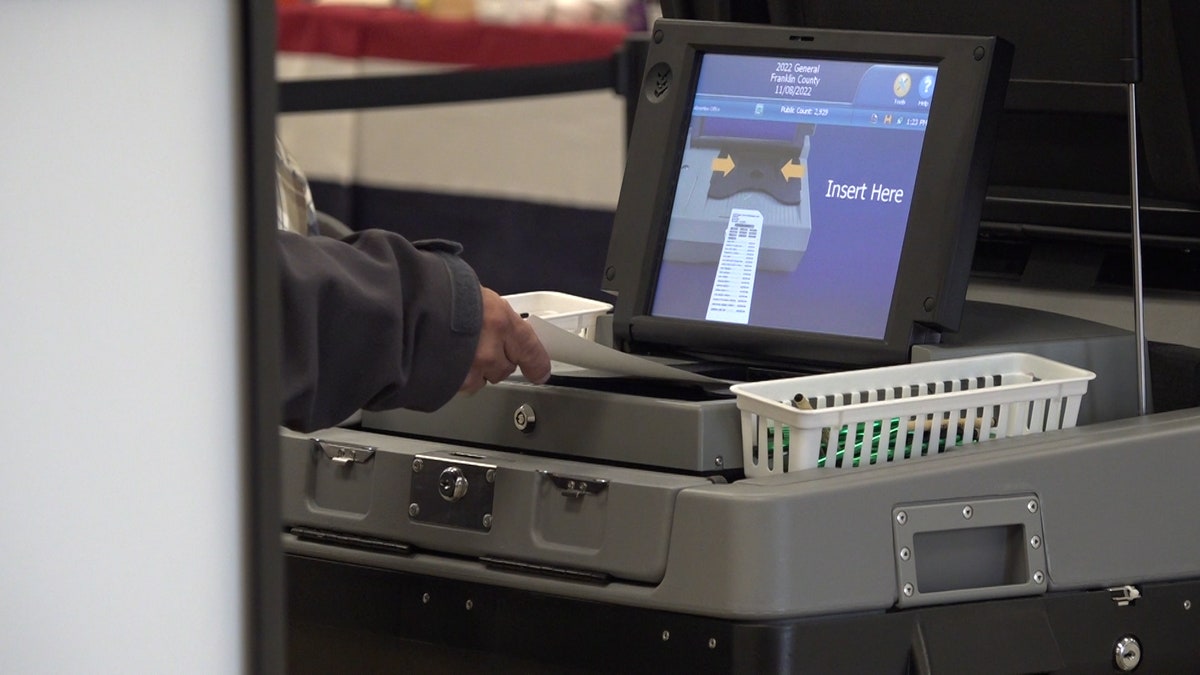 paper ballot fed into voting machine