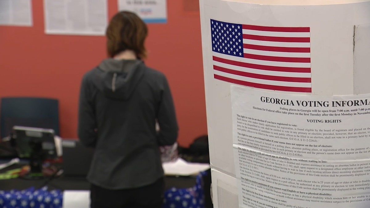 woman standing in line to present voter identification