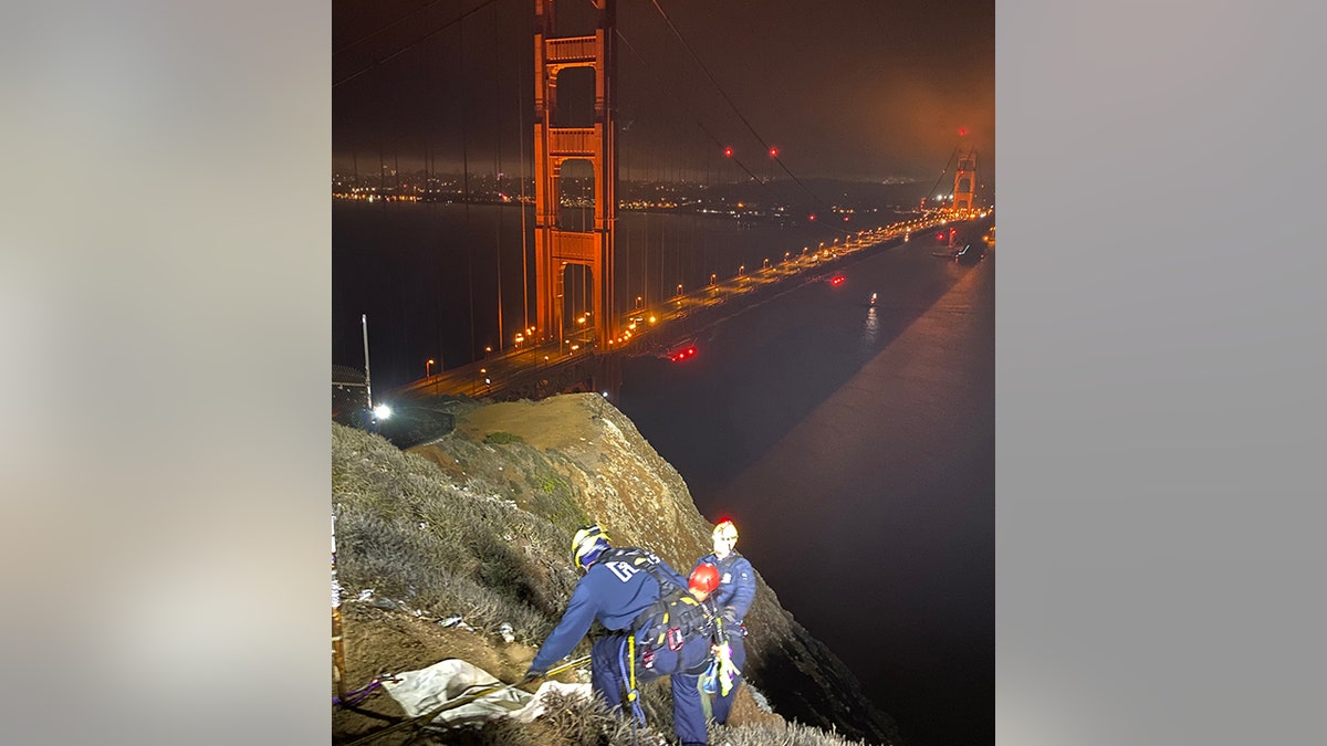 rescuers scaling cliff near Golden Gate Bridge