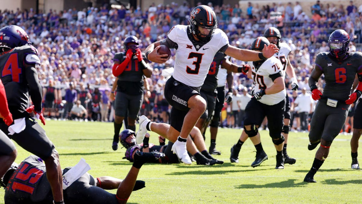 Spencer Sanders leaps across the goal line