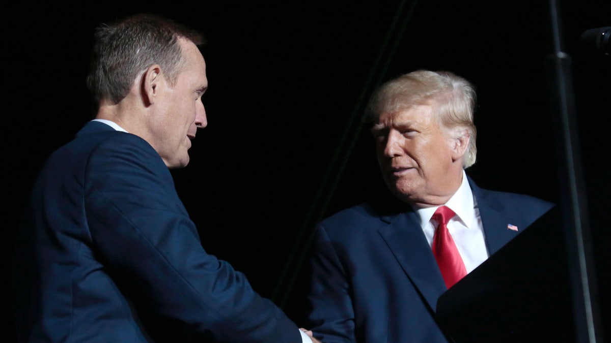 Former President Donald Trump, right, headlines a rally for Rep. Ted Budd, the Republican Senate nominee in North Carolina, on, Sept. 23, 2022, in Wilmington, N.C. (AP Photo/Chris Seward)