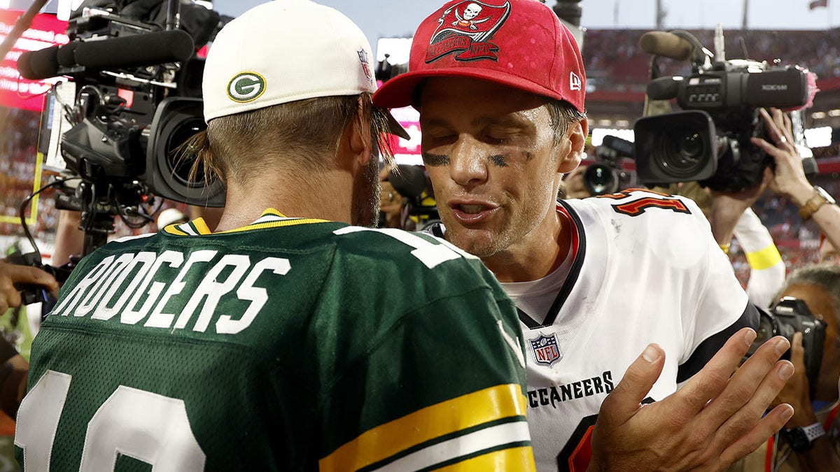 Tom Brady greets Aaron Rodgers