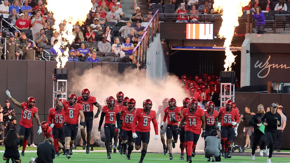 UNLV players run to the field