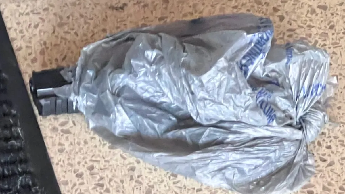 A gun wrapped in a plastic bag at Chicago police station
