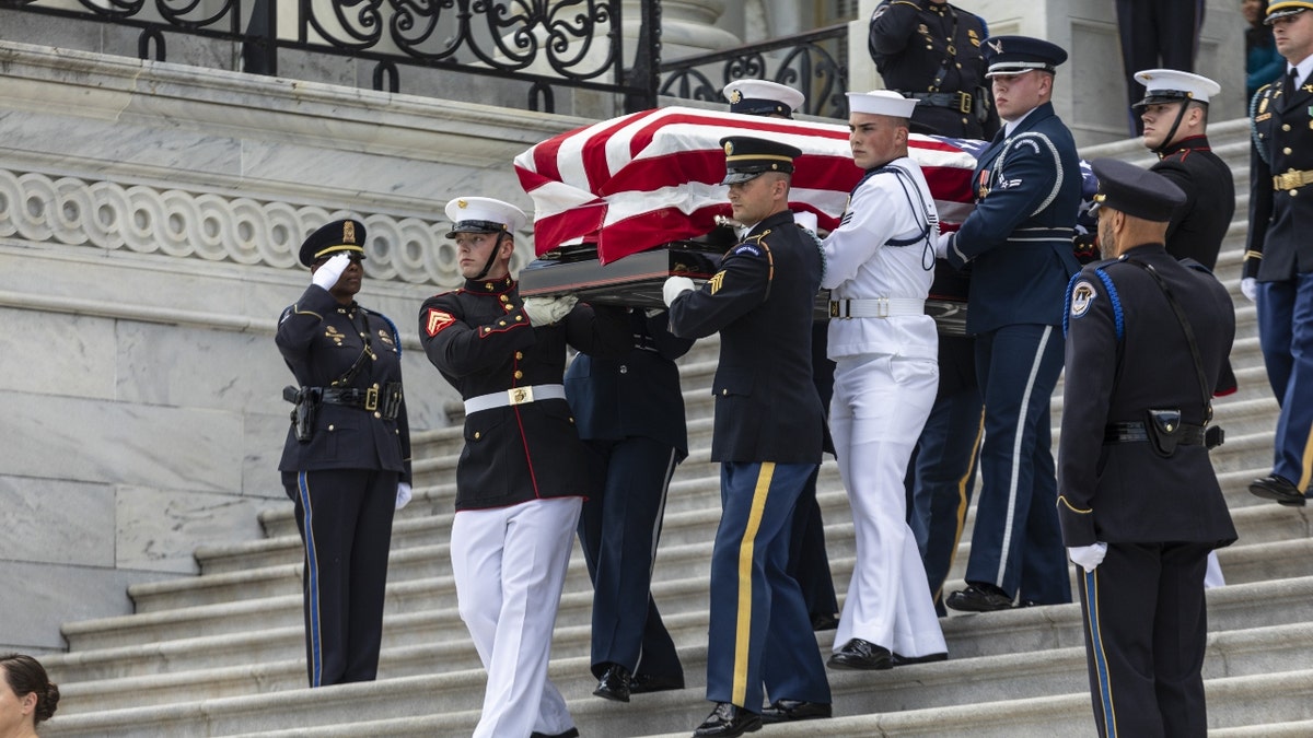 Honor guard carrying casket of Woody Williams.