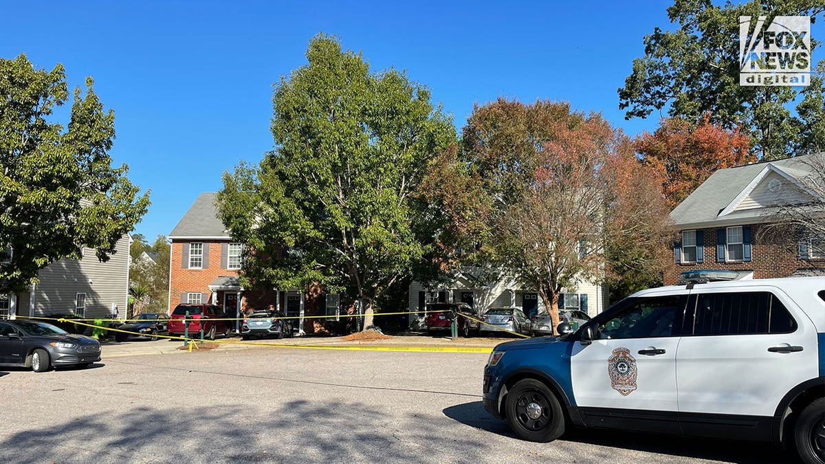 raleigh north carolina police car parked in front of homes with crime scene tape