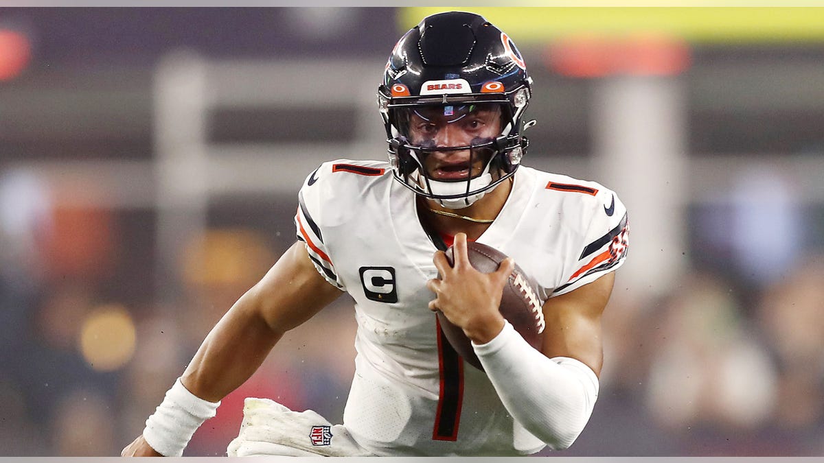 Justin Fields carries ball