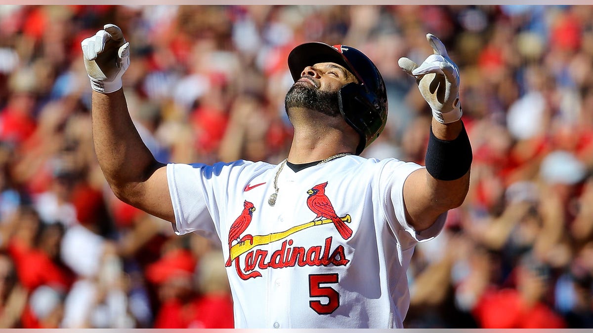 Albert Pujols of the St. Louis Cardinals gestures skyward at Busch Stadium