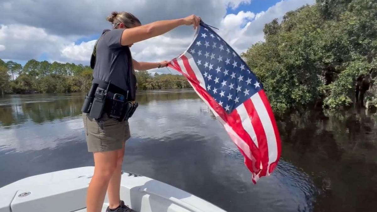 Woman on a boat holding the American flag
