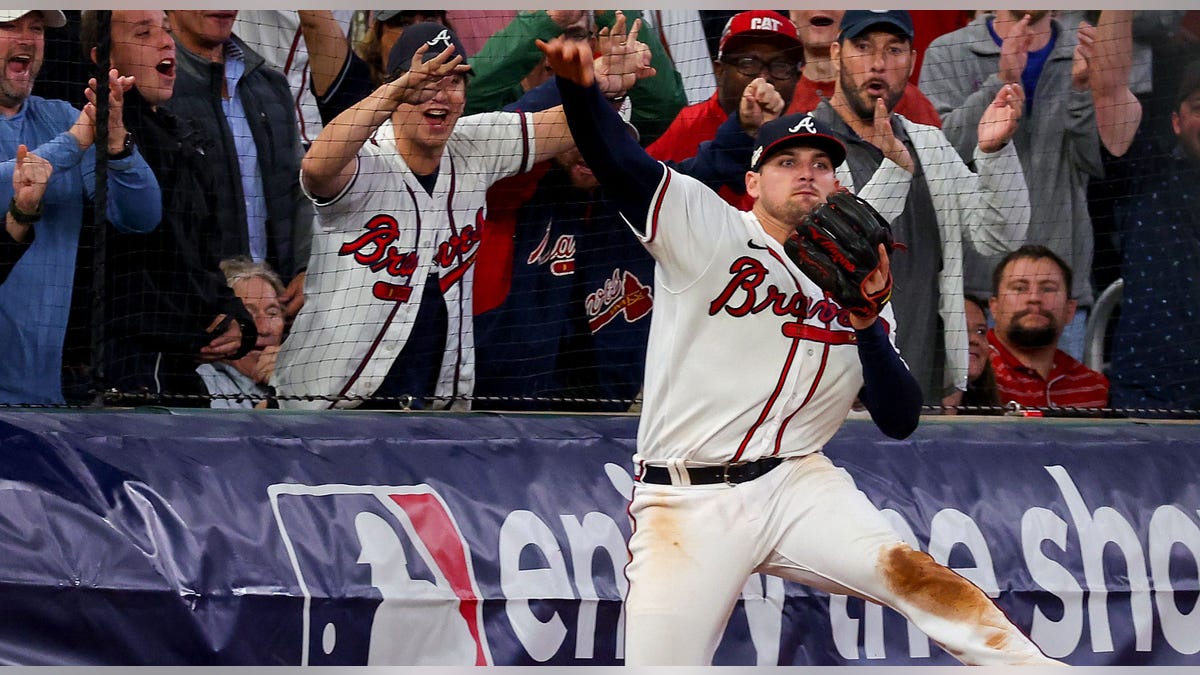 Austin Riley #27 of the Atlanta Braves throws the ball 