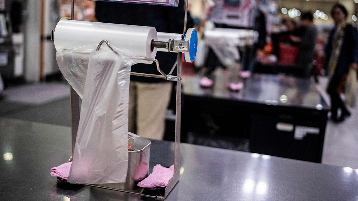 photo of plastic bag dispenser on a table in a store