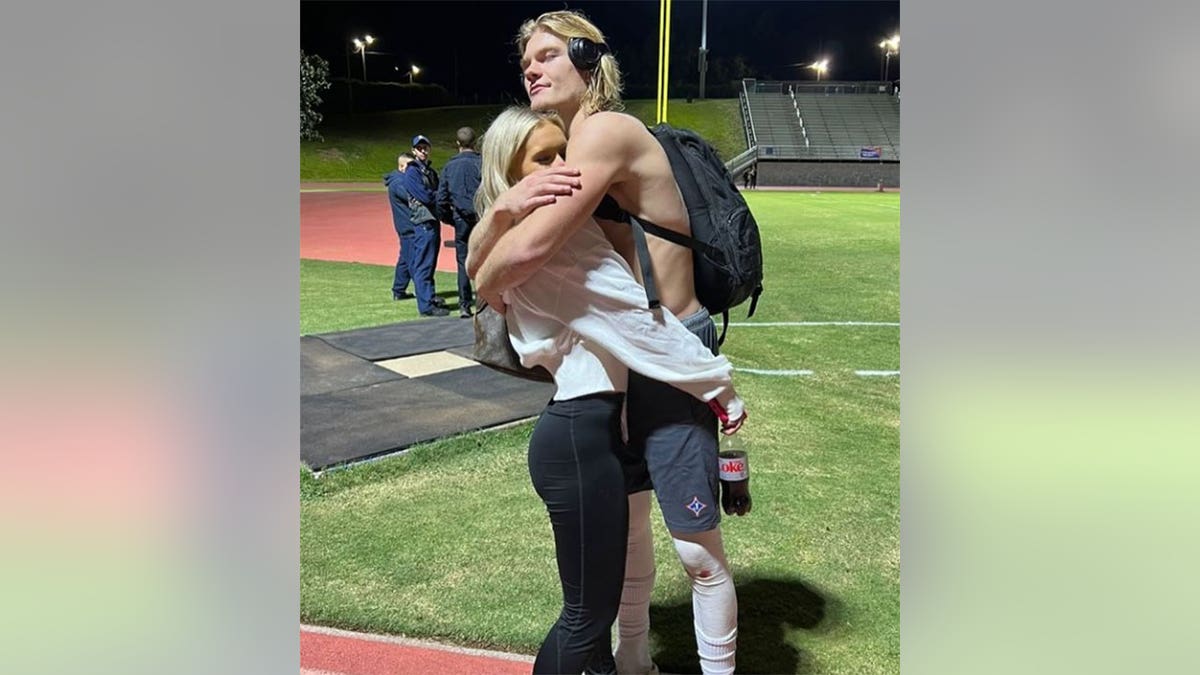 Elijah DeWitt hugs girlfriend