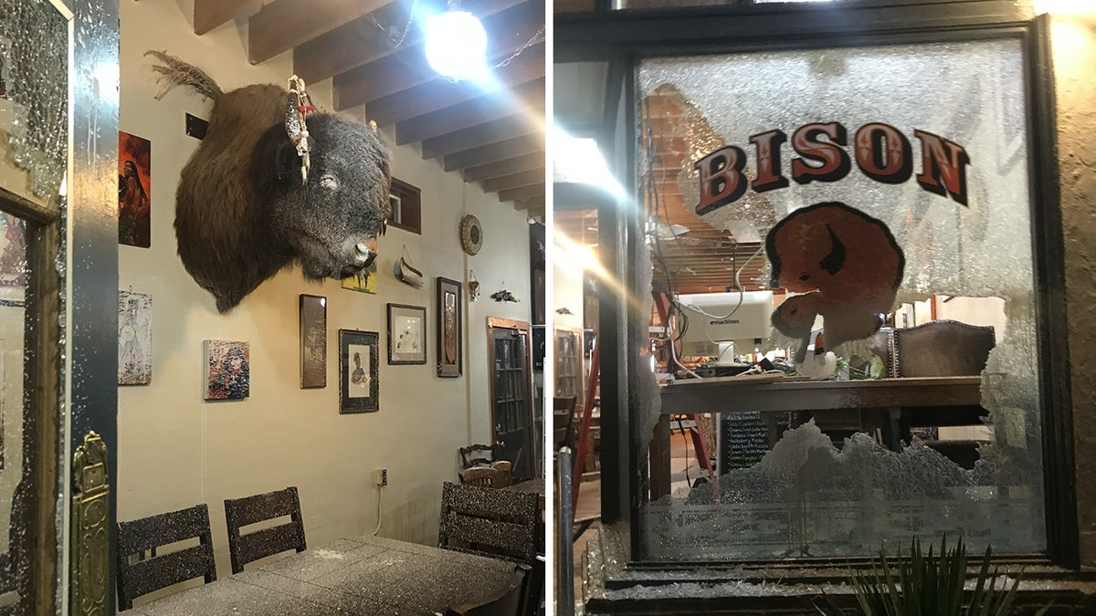 Paint covers tables, art, and a bison head and a window is shattered at Portland coffee shop