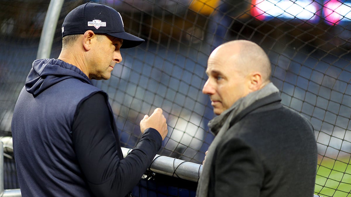 Aaron Boone and Brian Cashman during batting practice
