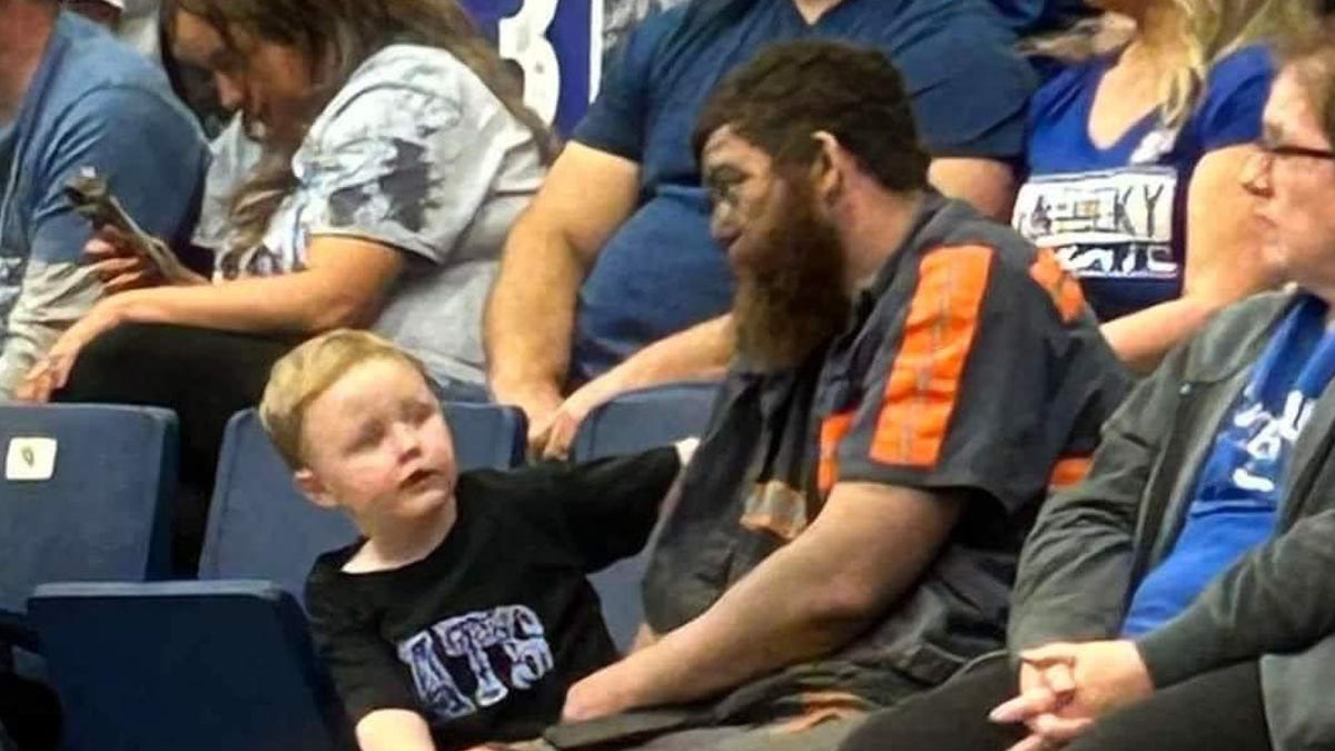Coal miner Michael McGuire sits with son at Kentucky game