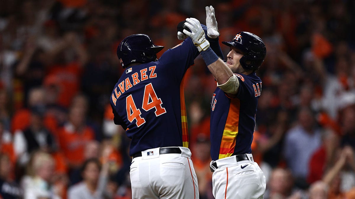 Alex Bregman and Yordan Alvarez celebrate