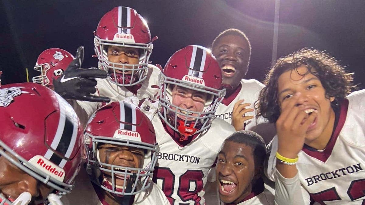 Group of Brockton High School football players pose for a picture