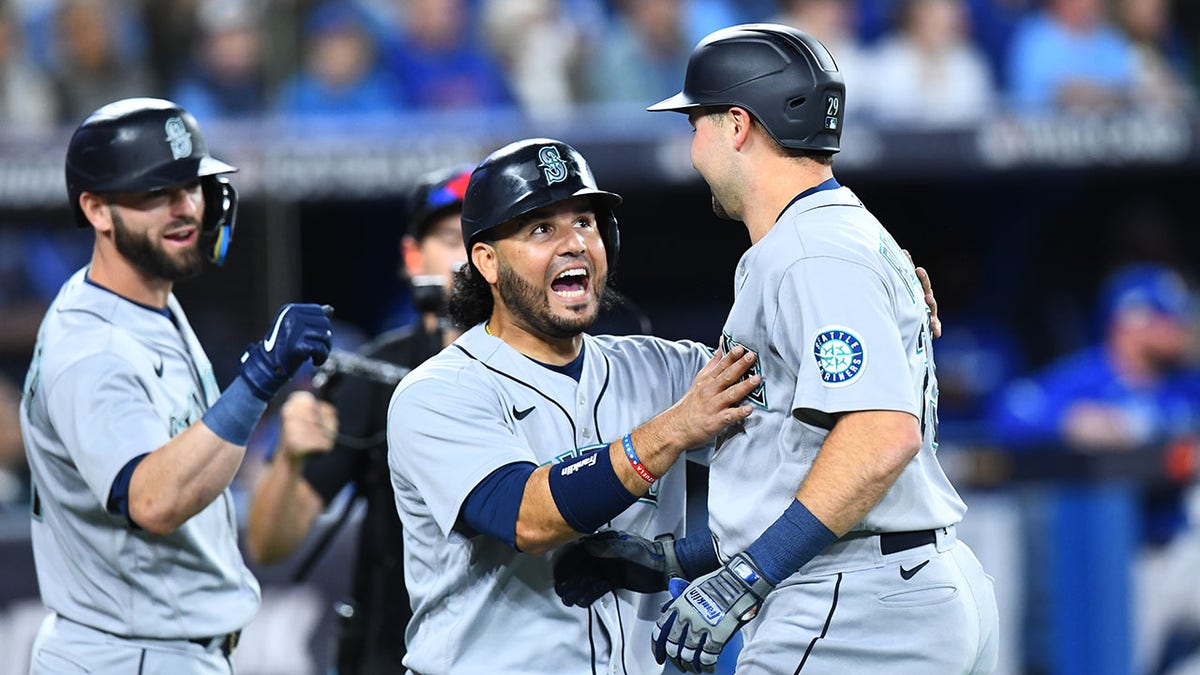 Cal Raleigh and Eugenio Suarez celebrate home run