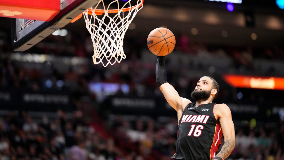 Heat s Caleb Martin tackles Raptors Christian Koloko into stands