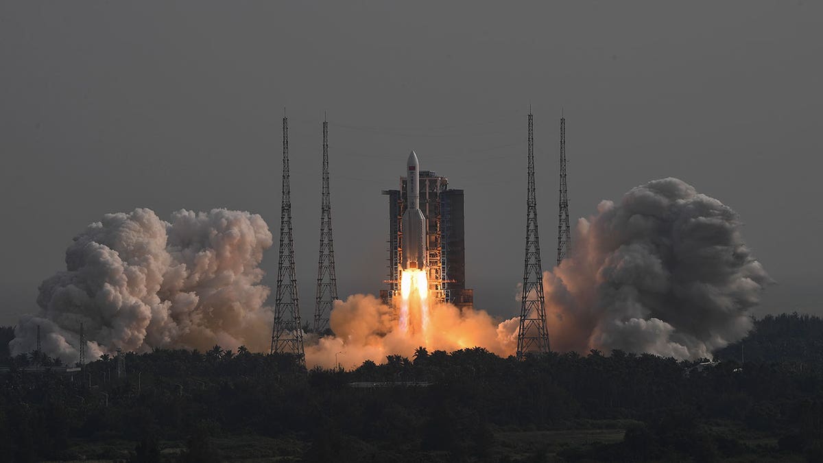 Space module launches, releasing smoke
