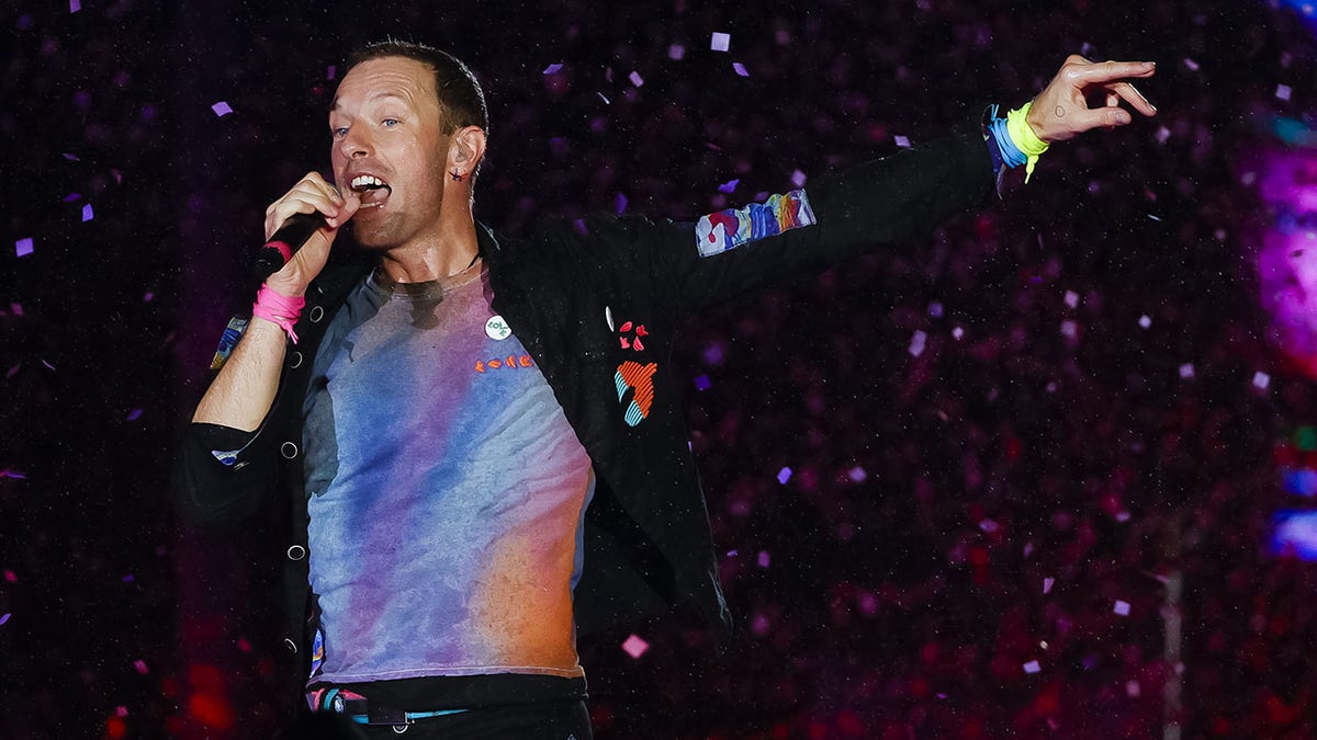 Chris Martin sings on stage in Rio