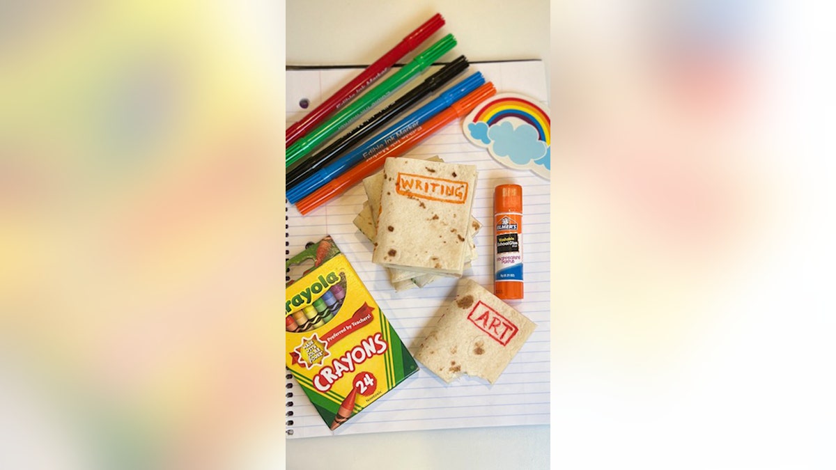 schoolbook sandwiches surrounded by school supplies