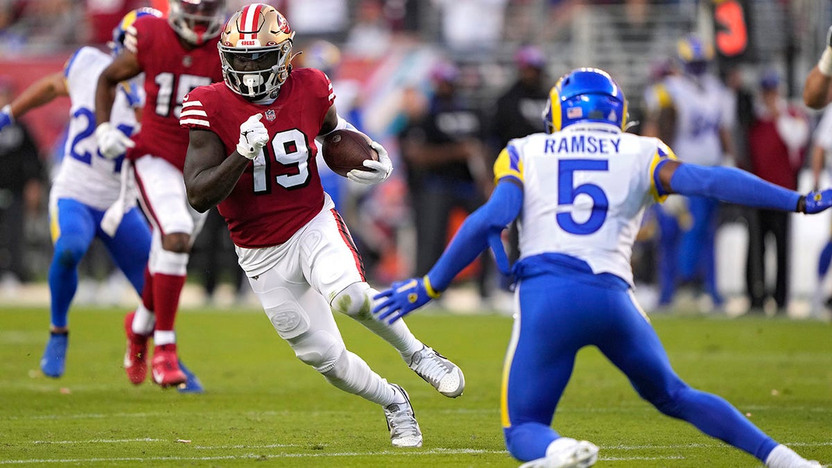 Deebo Samuel running by Jalen Ramsey