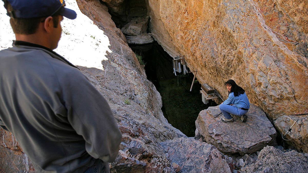 Biologist Mike Bower of the National Park Service, left, and Cynthia Martinez of the Fish and Wildlife Service work at Devils Hole, the only natural habitat to the endangered Devils Hole Pupfish, at Death Valley National Park in Nevada on April 6, 2006. 