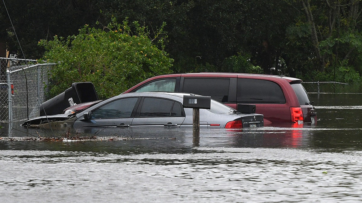 car and minivan in flood