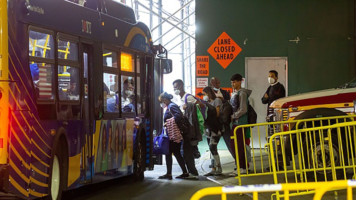 migrants board bus for nyc shelter