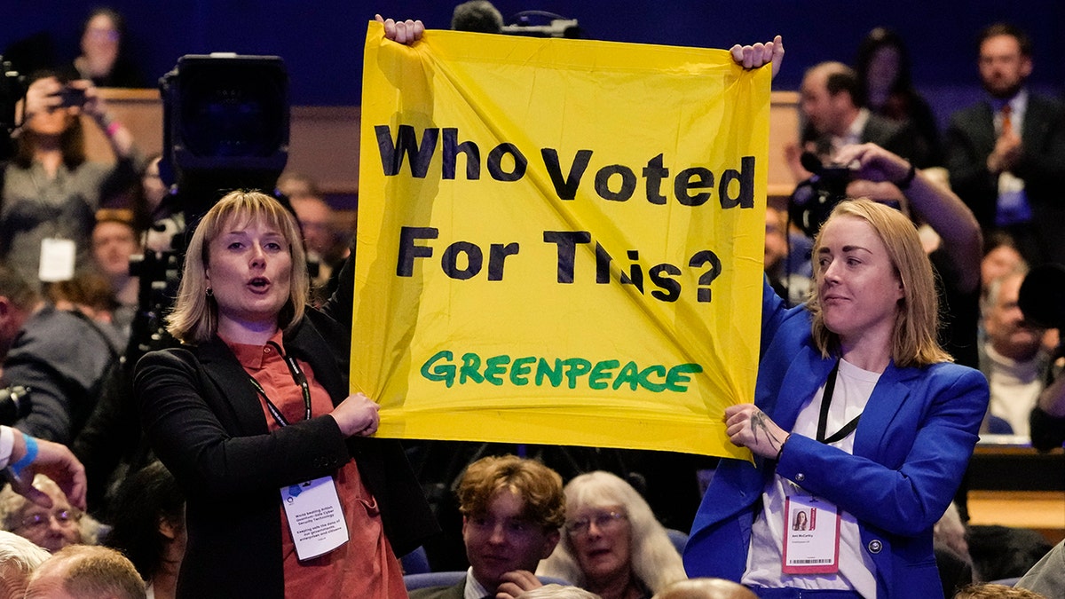 greenpeace activists holding banner