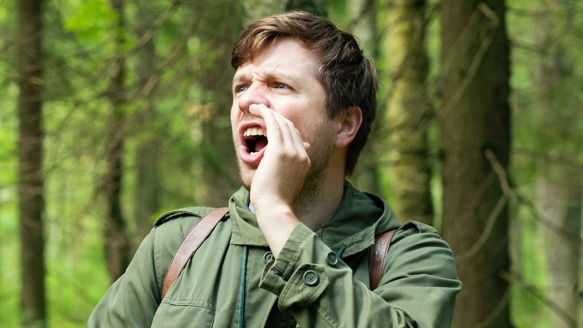 man yells in forest