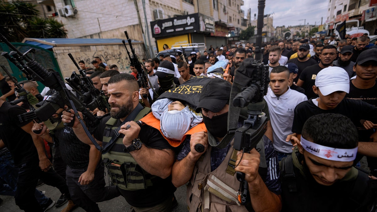 Mahmoud Al-Sous body being carried through crowd
